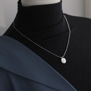 A necklace with a perfect combination of silver bead chains and pure natural pearls