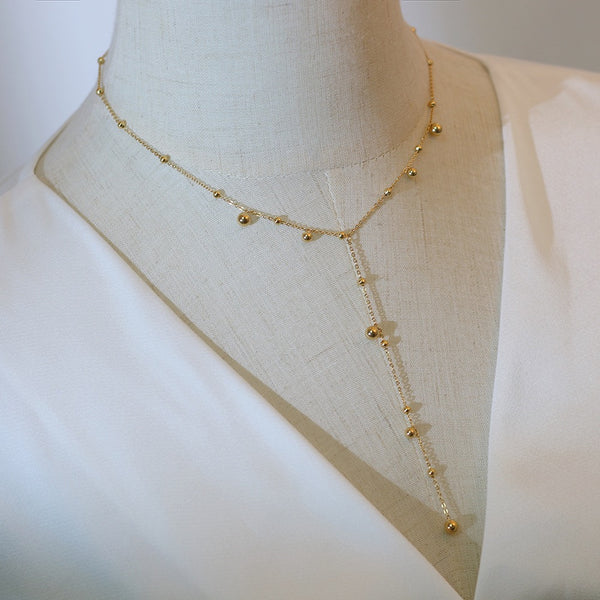 Irregular falling gold bead necklace