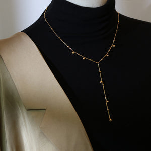 Irregular falling gold bead necklace