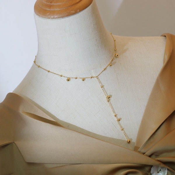 Irregular falling gold bead necklace