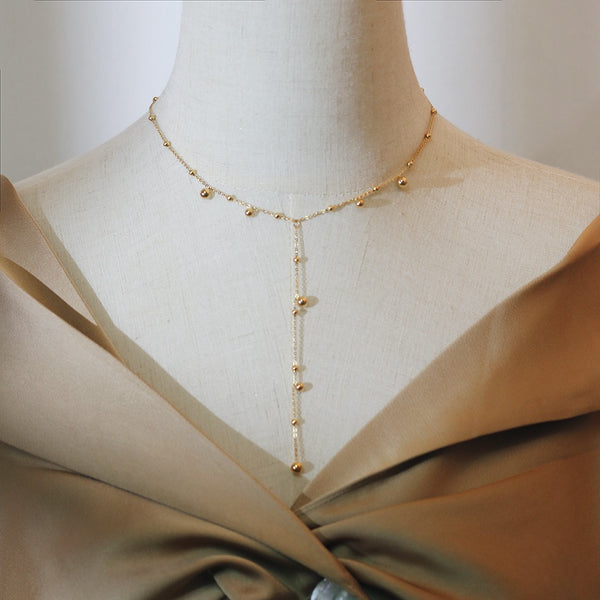 Irregular falling gold bead necklace